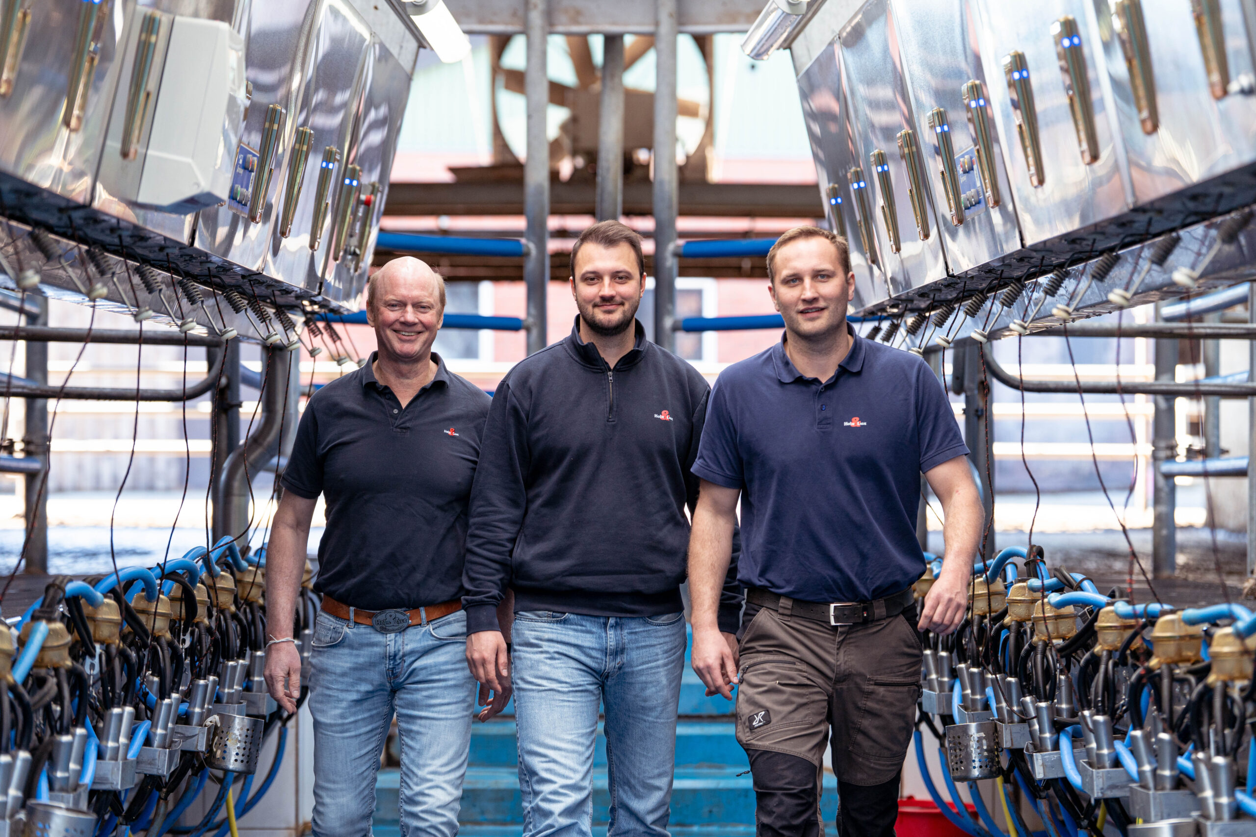 Achim Holm, Hannes Holm und Marco Schulz im Melkstand